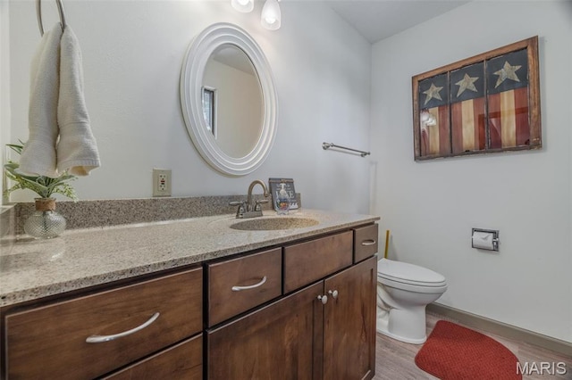 31 N Lionshead Dr, Innsbrook, MO 63390 - bathroom featuring wood finished floors, toilet, vanity, and baseboards