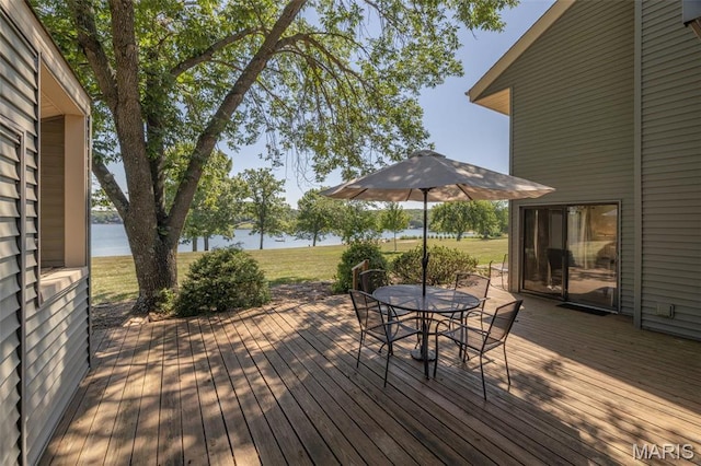 31 N Lionshead Dr, Innsbrook, MO 63390 - wooden deck with outdoor dining area, a water view, and a yard