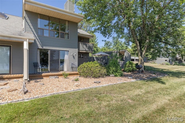 31 N Lionshead Dr, Innsbrook, MO 63390 - back of house featuring a lawn and a chimney