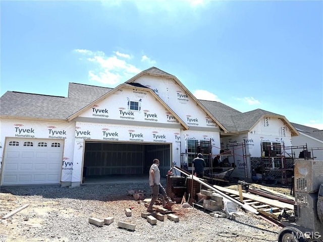 unfinished property with a garage and driveway