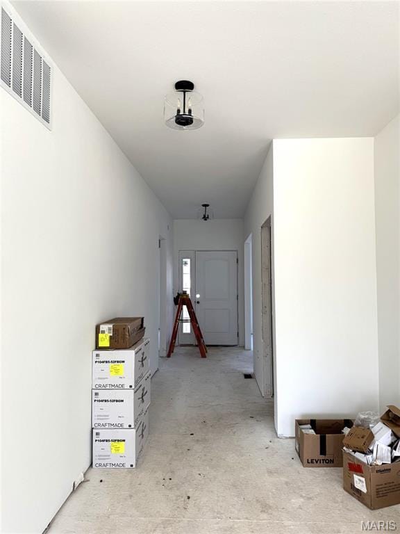 hallway with concrete floors