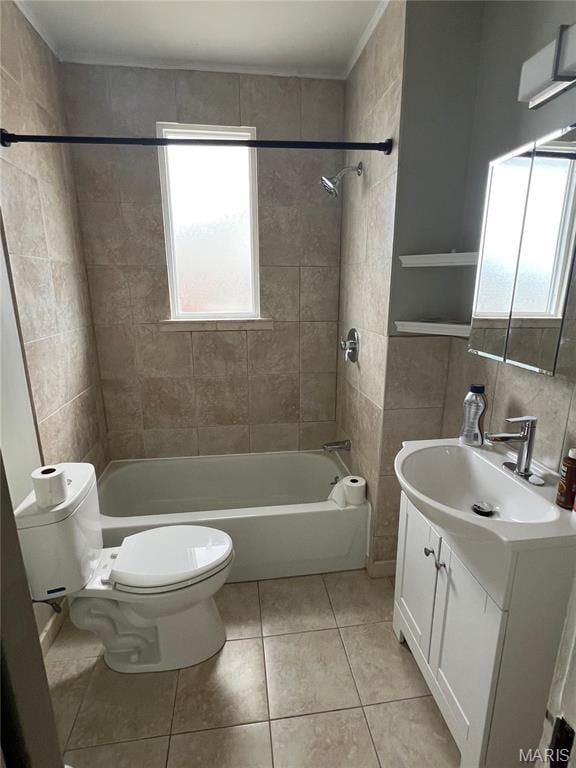 2326 Patton Ave, Saint Louis, MO 63144 - full bathroom featuring tile patterned floors, toilet, washtub / shower combination, vanity, and tile walls