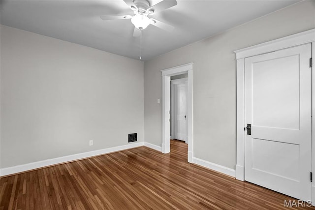 2326 Patton Ave, Saint Louis, MO 63144 - unfurnished bedroom with baseboards, wood finished floors, and a ceiling fan