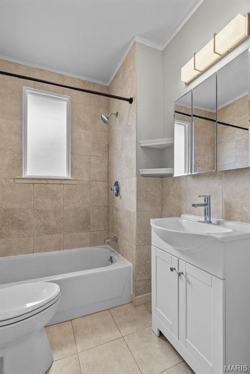 2326 Patton Ave, Saint Louis, MO 63144 - bathroom with tile patterned floors, crown molding, toilet, vanity, and shower / bathtub combination