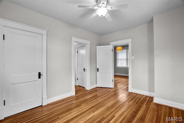 2326 Patton Ave, Saint Louis, MO 63144 - unfurnished bedroom with baseboards, light wood finished floors, and a ceiling fan