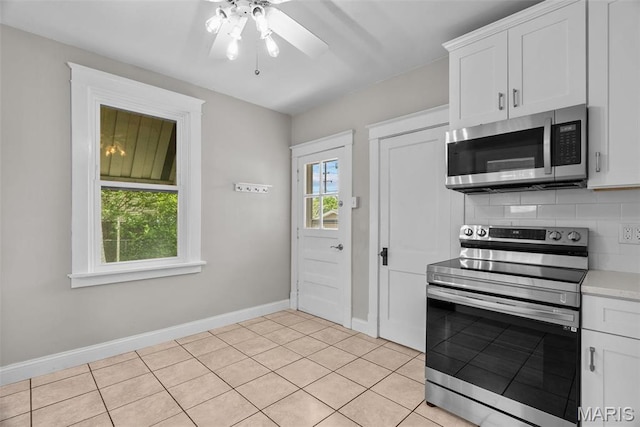 2326 Patton Ave, Saint Louis, MO 63144 - kitchen featuring stainless steel appliances, baseboards, ceiling fan, and white cabinetry