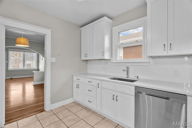 2326 Patton Ave, Saint Louis, MO 63144 - kitchen with stainless steel dishwasher, a sink, healthy amount of natural light, and tasteful backsplash