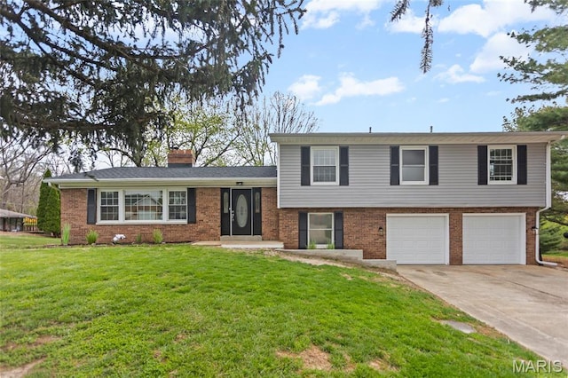 split level home featuring a garage, brick siding, driveway, a chimney, and a front lawn