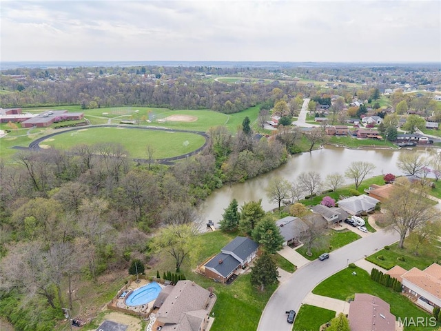 aerial view of property's location featuring a large body of water and nearby suburban area