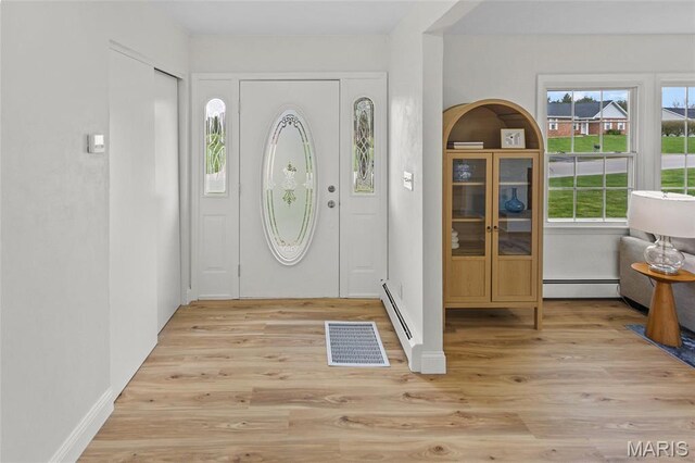 entryway with a baseboard radiator and light wood-style flooring