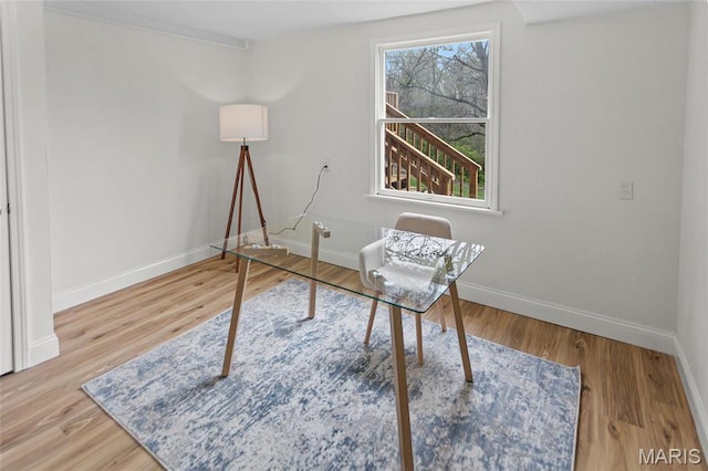 office space featuring baseboards and wood finished floors