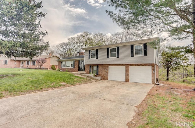 tri-level home featuring concrete driveway, an attached garage, brick siding, and a front yard