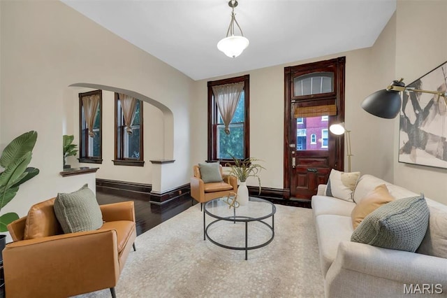 2811 Pennsylvania Ave, Saint Louis, MO 63118 - living area featuring wood finished floors, arched walkways, and baseboards