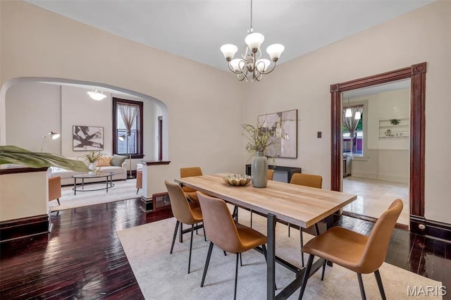 2811 Pennsylvania Ave, Saint Louis, MO 63118 - dining space with arched walkways, hardwood / wood-style floors, and a chandelier