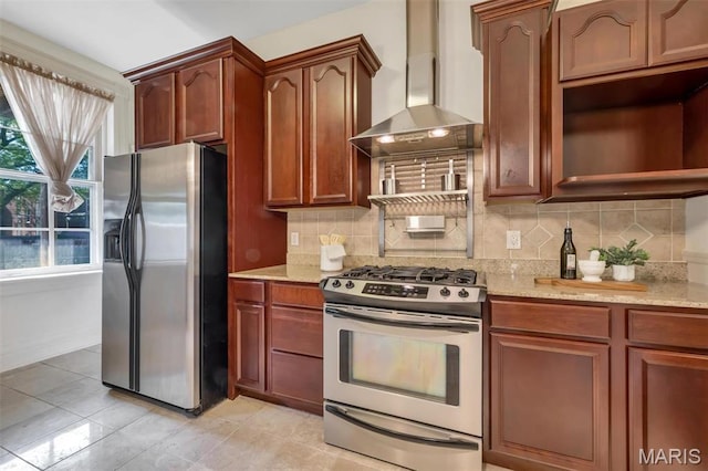 2811 Pennsylvania Ave, Saint Louis, MO 63118 - kitchen with appliances with stainless steel finishes, light stone countertops, wall chimney range hood, tasteful backsplash, and light tile patterned floors