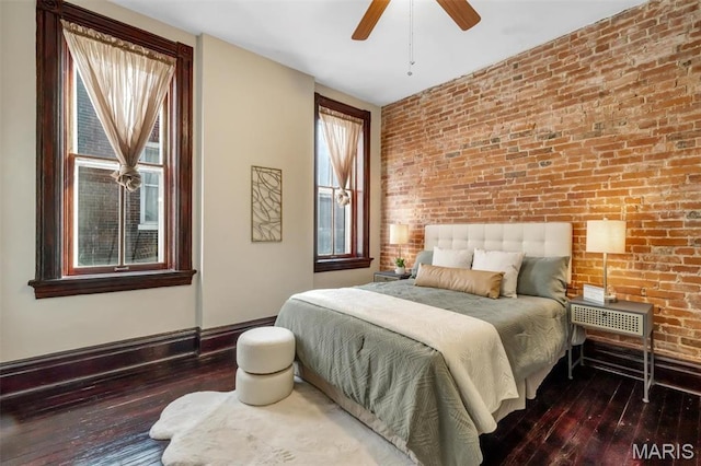 2811 Pennsylvania Ave, Saint Louis, MO 63118 - bedroom with wood-type flooring, brick wall, baseboards, multiple windows, and a ceiling fan