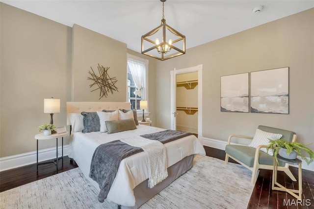 2811 Pennsylvania Ave, Saint Louis, MO 63118 - bedroom with a chandelier, baseboards, and wood finished floors
