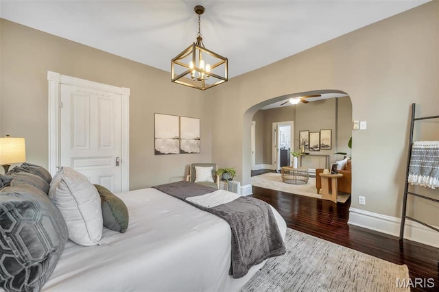 2811 Pennsylvania Ave, Saint Louis, MO 63118 - bedroom featuring arched walkways, wood finished floors, a chandelier, and baseboards