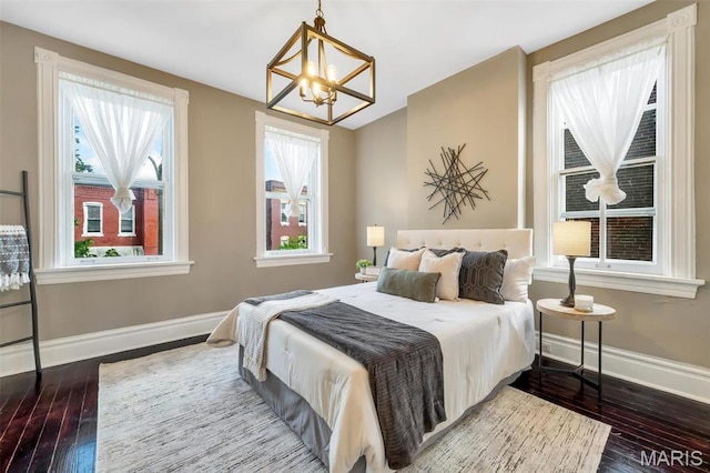 2811 Pennsylvania Ave, Saint Louis, MO 63118 - bedroom featuring a chandelier, dark wood-style floors, and baseboards