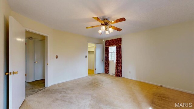 1402 Liberty Dr, Rolla, MO 65401 - empty room with light carpet, a ceiling fan, and baseboards