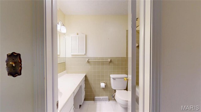 1402 Liberty Dr, Rolla, MO 65401 - bathroom with tile patterned flooring, vanity, tile walls, toilet, and wainscoting