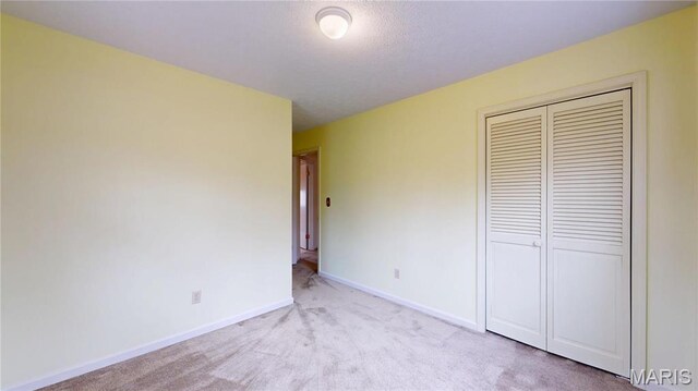 1402 Liberty Dr, Rolla, MO 65401 - unfurnished bedroom featuring carpet, a closet, and baseboards