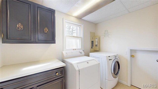 1402 Liberty Dr, Rolla, MO 65401 - laundry area featuring independent washer and dryer, cabinet space, and light tile patterned flooring