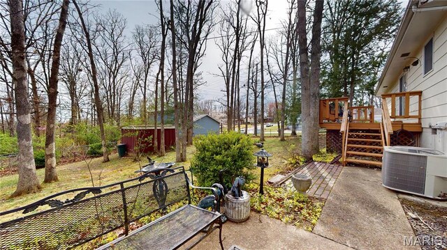 1402 Liberty Dr, Rolla, MO 65401 - view of yard featuring central AC unit, a deck, stairway, and a patio area