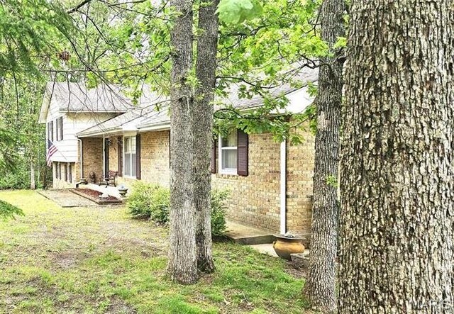 1402 Liberty Dr, Rolla, MO 65401 - view of home's exterior featuring brick siding and a lawn