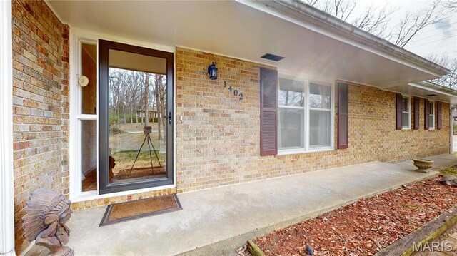 1402 Liberty Dr, Rolla, MO 65401 - view of exterior entry featuring brick siding