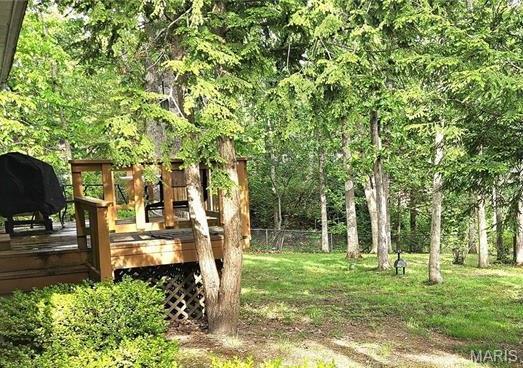 1402 Liberty Dr, Rolla, MO 65401 - view of yard featuring a deck and a forest view