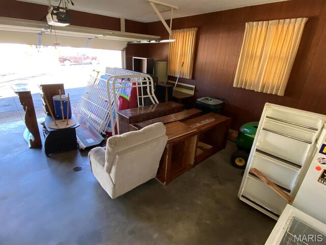 1402 Liberty Dr, Rolla, MO 65401 - garage featuring a garage door opener and wooden walls