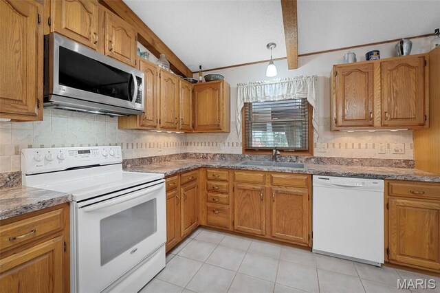 kitchen featuring white appliances, a sink, vaulted ceiling, tasteful backsplash, and light tile patterned floors