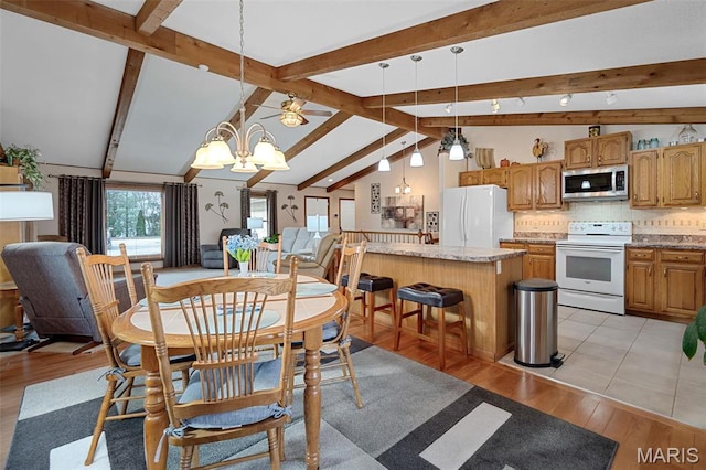 dining space featuring light wood-type flooring and a ceiling fan