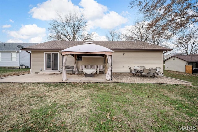 back of house featuring a gazebo, a patio, and a lawn