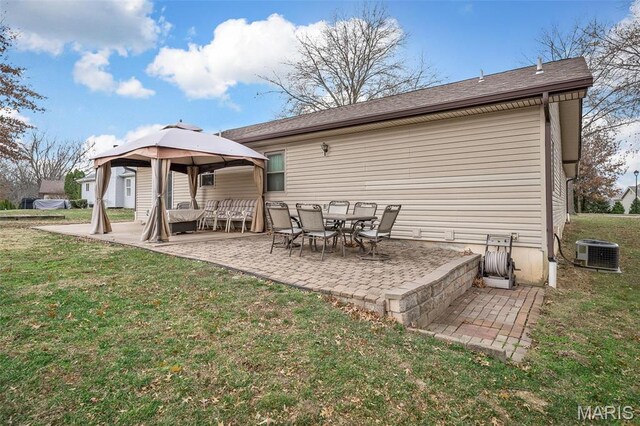 back of property featuring a gazebo, cooling unit, a patio, and a yard