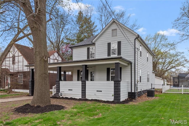 view of front of property with covered porch, ceiling fan, and central air condition unit