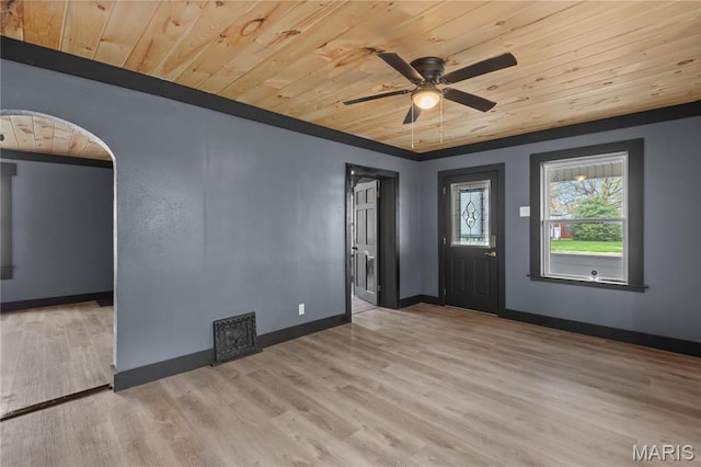 spare room featuring wooden ceiling, ceiling fan, wood finished floors, arched walkways, and baseboards