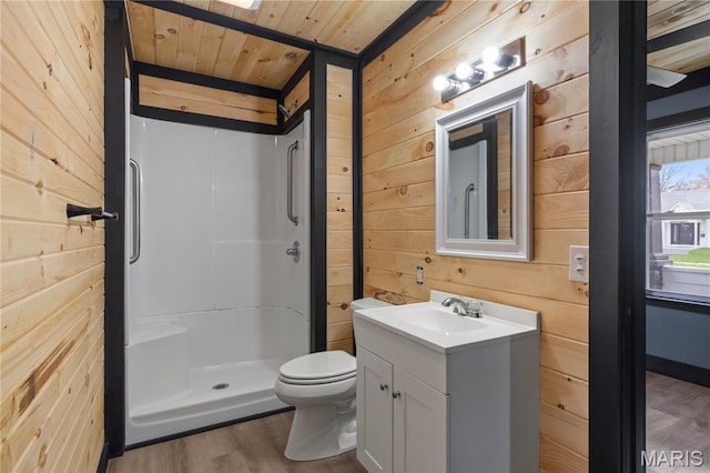 full bath featuring wood walls, a stall shower, wooden ceiling, wood finished floors, and vanity