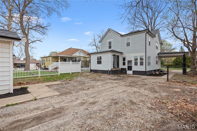 rear view of property with a carport