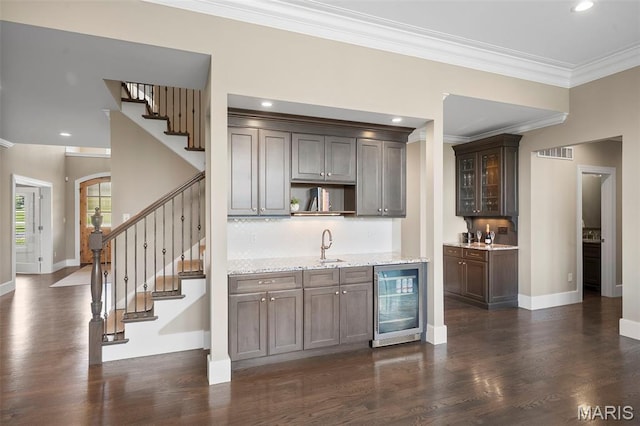 13750 Stonemont Ct, Town And Country, MO 63131 - indoor wet bar featuring beverage cooler, dark wood-type flooring, crown molding, baseboards, and recessed lighting