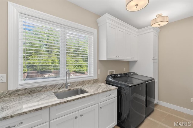 13750 Stonemont Ct, Town And Country, MO 63131 - laundry room featuring separate washer and dryer, cabinet space, baseboards, and light tile patterned floors