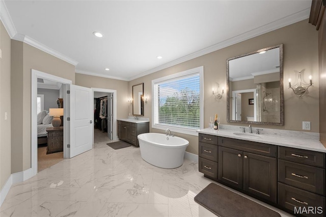 13750 Stonemont Ct, Town And Country, MO 63131 - bathroom featuring two vanities, a soaking tub, crown molding, baseboards, and recessed lighting