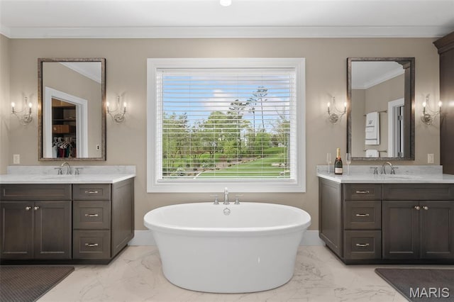 13750 Stonemont Ct, Town And Country, MO 63131 - bathroom featuring marble finish flooring, two vanities, a freestanding tub, plenty of natural light, and crown molding