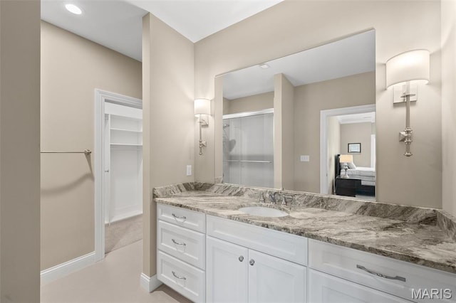13750 Stonemont Ct, Town And Country, MO 63131 - bathroom with a stall shower, vanity, a walk in closet, baseboards, and recessed lighting
