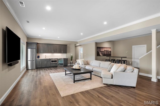 13750 Stonemont Ct, Town And Country, MO 63131 - living room with baseboards, bar with sink, wood finished floors, crown molding, and recessed lighting