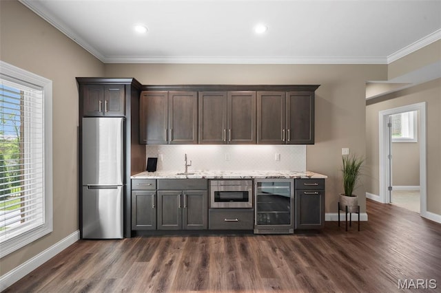 13750 Stonemont Ct, Town And Country, MO 63131 - kitchen featuring freestanding refrigerator, wine cooler, baseboards, decorative backsplash, and ornamental molding