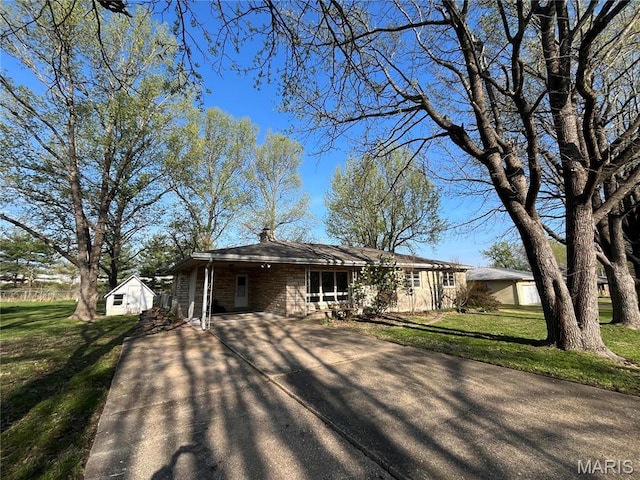 503 N Louise Ave, St James, MO 65559 - view of front of home with asphalt driveway, a front lawn, a carport, and a chimney