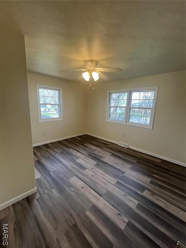 503 N Louise Ave, St James, MO 65559 - unfurnished room with plenty of natural light, baseboards, ceiling fan, and dark wood-style flooring