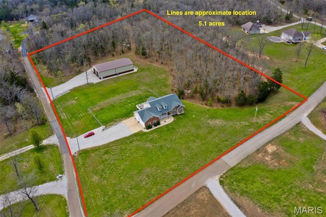 view from above of property featuring property boundaries highlighted and a heavily wooded area